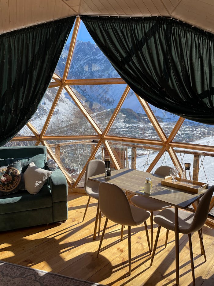 View from inside of a dome-style glamping accommodation with breakfast table.